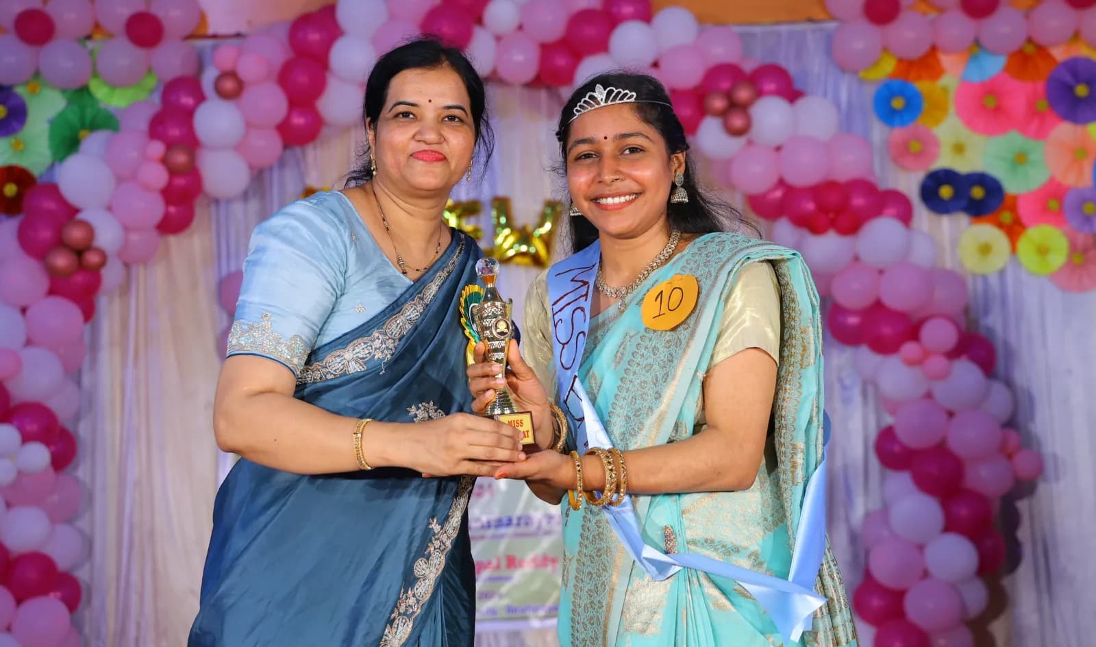 Student receiving a trophy during the college farewell ceremony