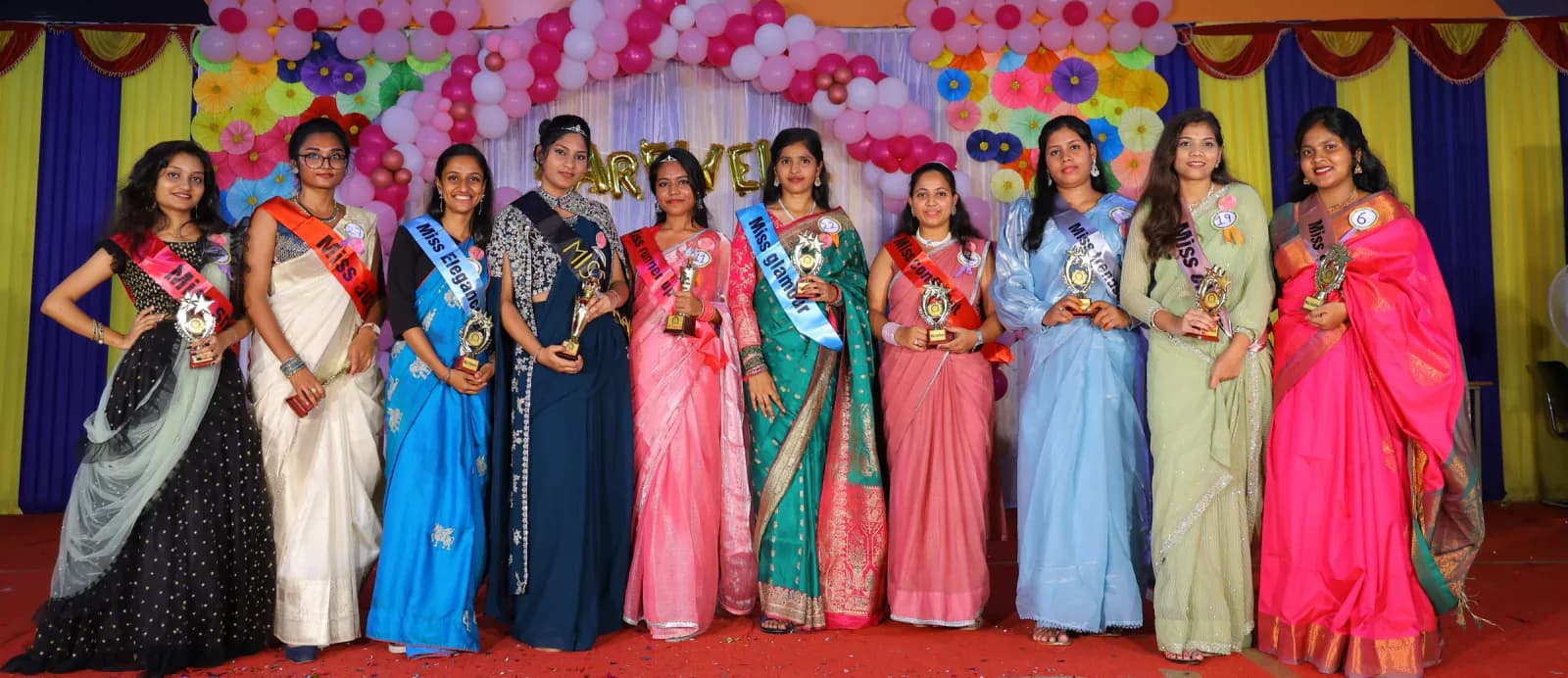 Award winners lined up on stage at a college event